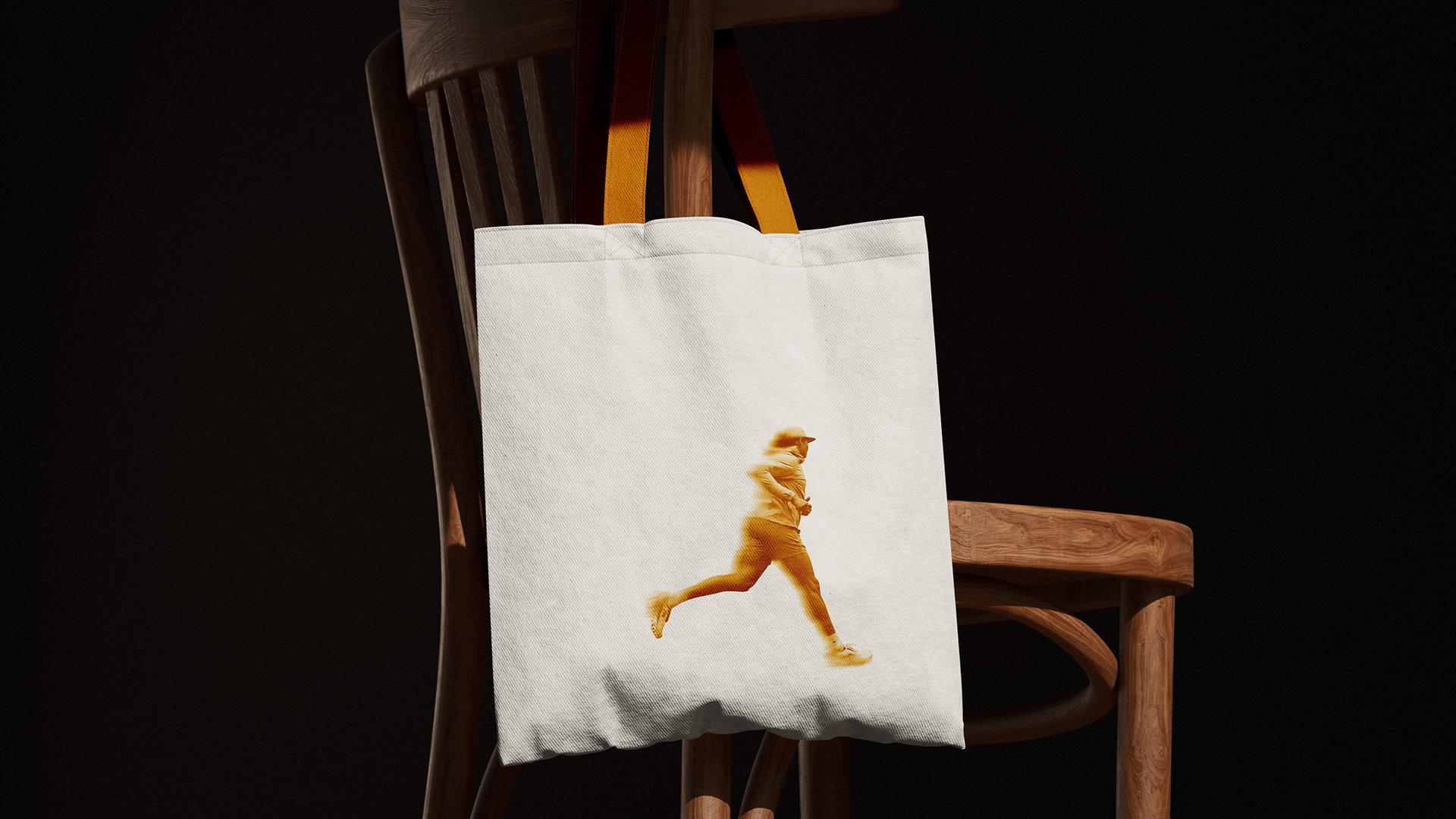 2nd Wind tote bag with runner silhouette, on a chair